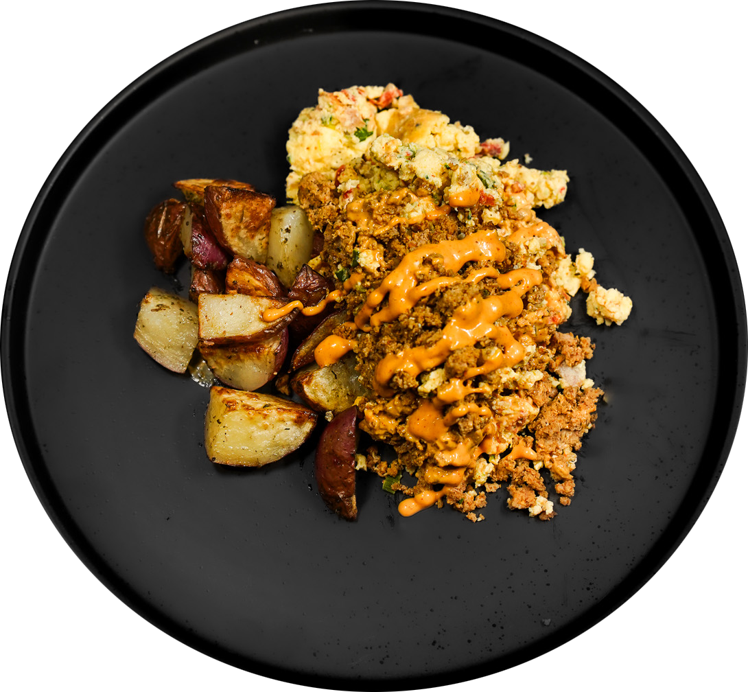 Prepared breakfast potatoes and eggs on a black plate