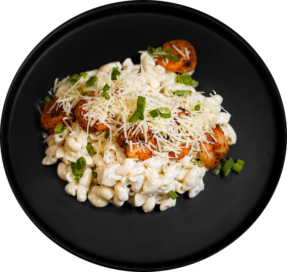 Prepared pasta and vegetables on a black plate